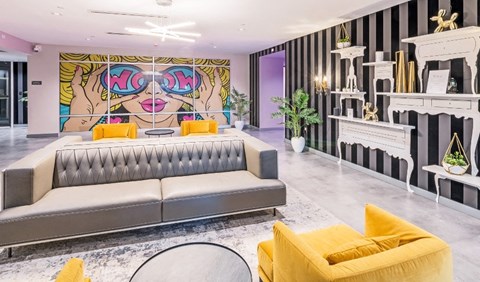 a living room with a couch and a painting on the wall